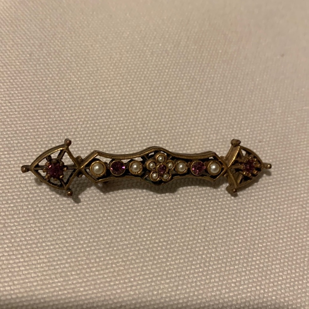 Bronze/brass vintage pin with pearl and amethyst colored crystal stones.